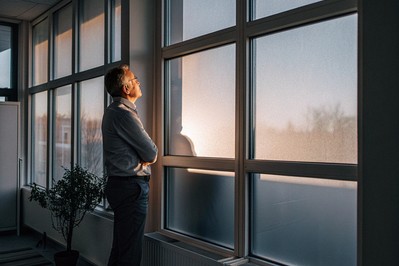 Leader pausing at sunrise by a window