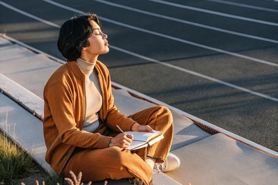 Founder journaling at sunrise track, practicing box breathing
