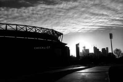 sunrise over stadium and financial district skyline
