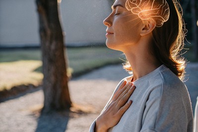 Person pausing hand-on-heart with soft brain overlay