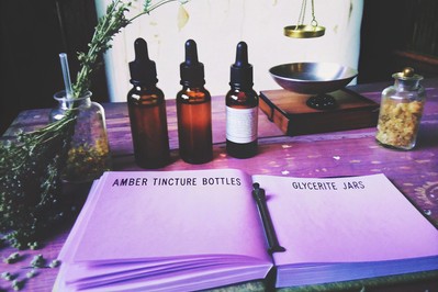 Work table with tinctures, glycerites, scale, and open safety handbook