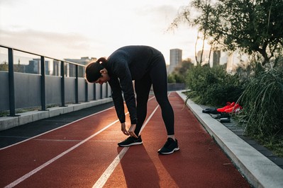 athlete at sunrise on city track
