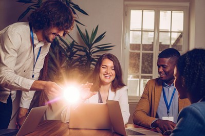 Professional enjoying team-based learning with visible badges and peers