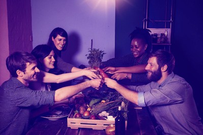 diverse cohort sharing plant-forward meal after cooking class