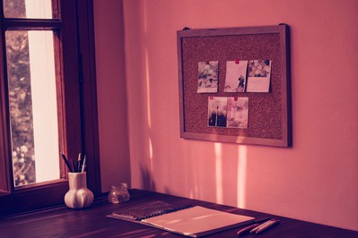 vision board with career, learning, finance, wellbeing items behind a desk