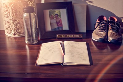 sunlit desk with open notebook and family photo