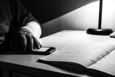 Person silencing phone while time-blocking calendar