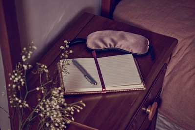 bedside notebook and sleep headband on a nightstand