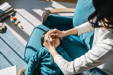 Parent kneeling to apologize to child