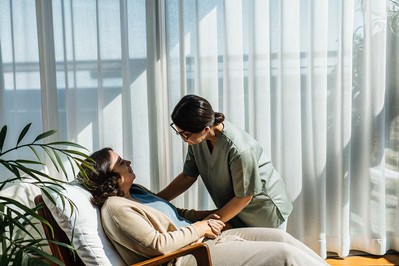 clinician guiding patient in diaphragmatic breathing