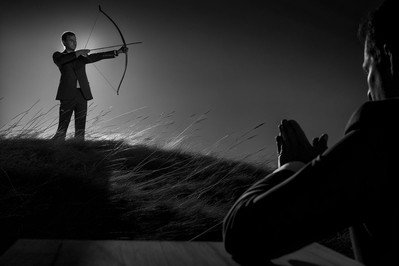 Archer practicing mindful breathing at sunset