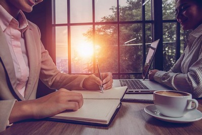 Professional journaling at sunrise with coffee