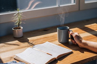 journaling beside a warm mug in morning light