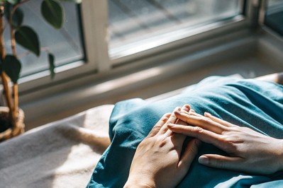 Hands over heart in morning light