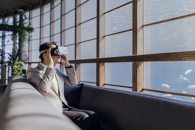 Executive using VR headset in a tranquil oceanarium setting with HRV wearable