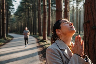 Executive taking a calm breath at sunrise in a forest