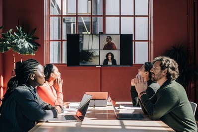Team sharing a quiet minute before a hybrid meeting