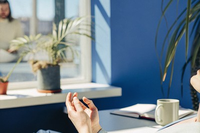 Calm worker pausing at desk with soft light