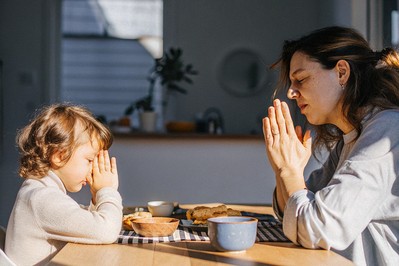 Parent and child exhale together at the kitchen table