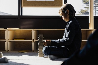 Student rebuilding a toppled paper-stone stack