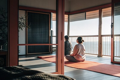 Sunrise yoga on a terrace overlooking a river valley